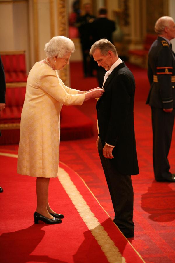 Queen Elizabeth II awards the MBE to GB cycling